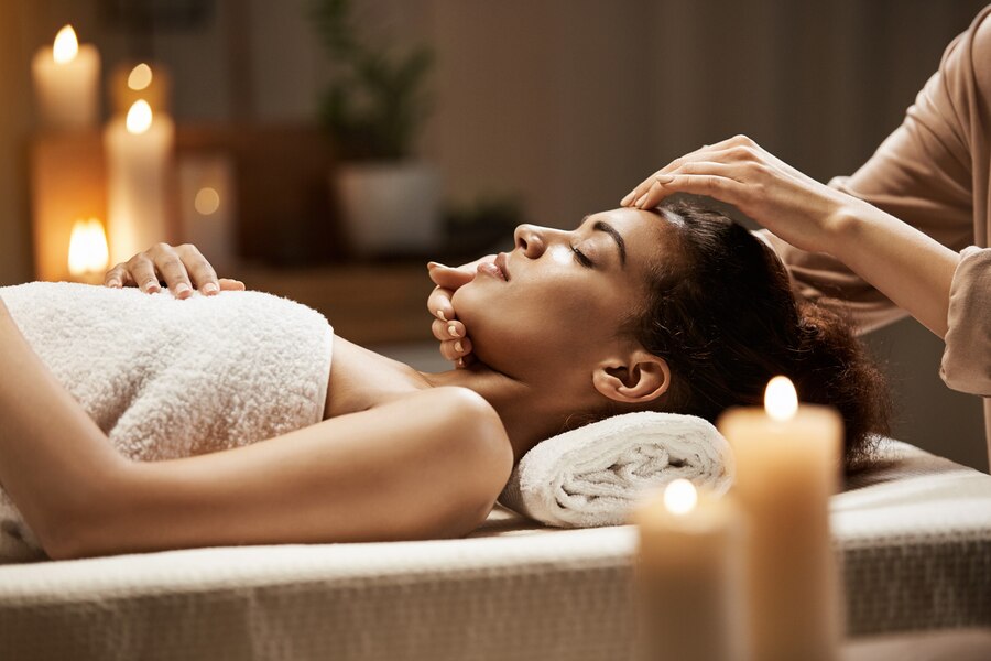 African woman face massage | Blowout Salon